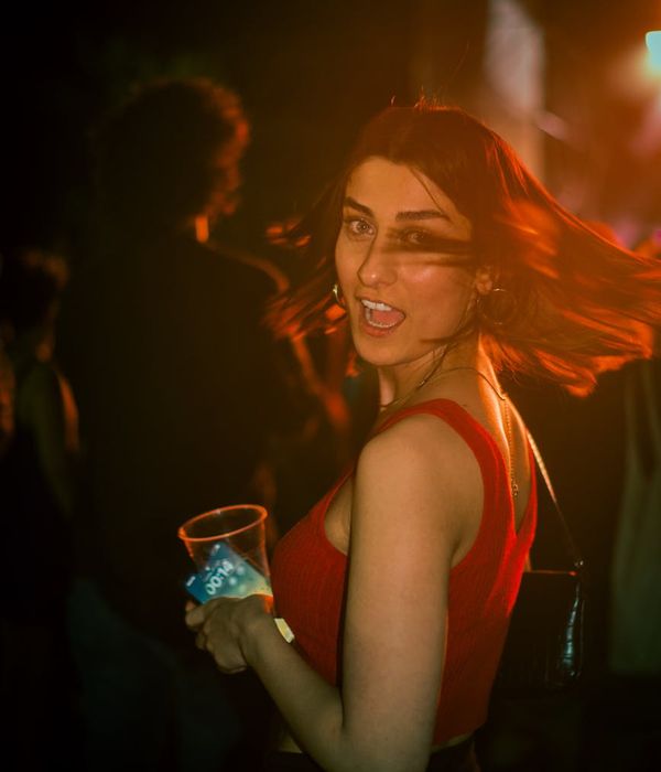 Person feeling vibrant and energetic against a dark background with amber highlights.